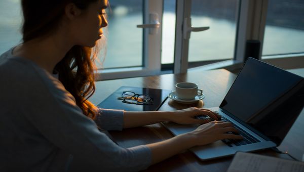 lady working on her laptop at a desk